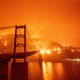 A boat motors by as the Bidwell Bar Bridge is surrounded by fire in Lake Oroville during the Bear fire in Oroville, California on September 9, 2020.